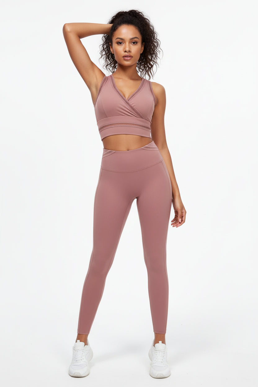 Woman wearing a pink athletic outfit on a white background