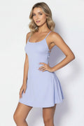 Woman wearing a light blue dress against a white background