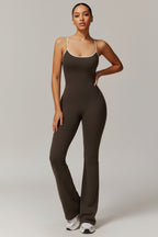 Person wearing a brown jumpsuit on a plain background